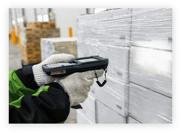 a warehouse worker scans barcodes on packages