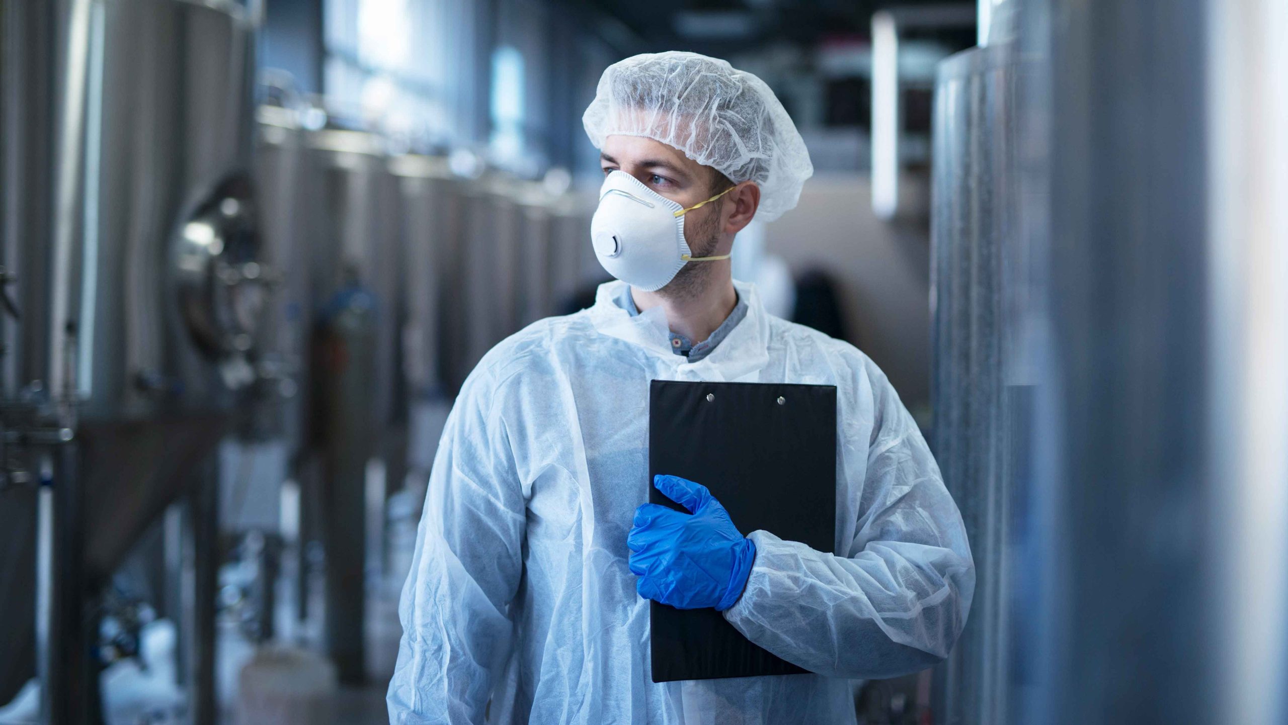 technologist-protective-white-suit-with-hairnet-mask-standing-food-factory
